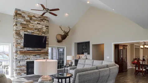 Living room with stone fireplace in a remodeled home from Garman builders