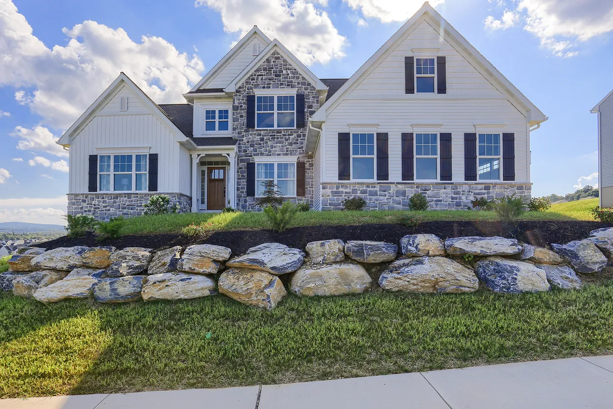 Front elevation of a luxury home with stone accents from Garman Builders