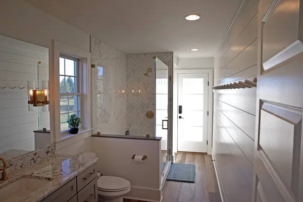Remodeled bathroom with glass door shower from Garman Builders