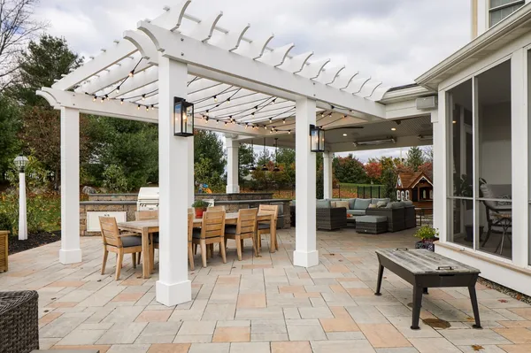 Outdoor patio with a pergola and a table with seating from Garman builders