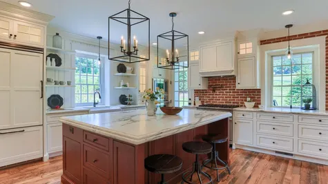 Remodeled Kitchen with white cabinets and center island from Garman Builders