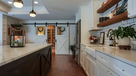 Kitchen with white cabinets and a center island in a home renovated by garman builders