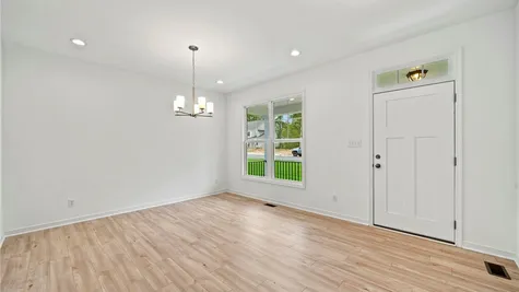 Spare room with light hardwood flooring and a wealth of natural light