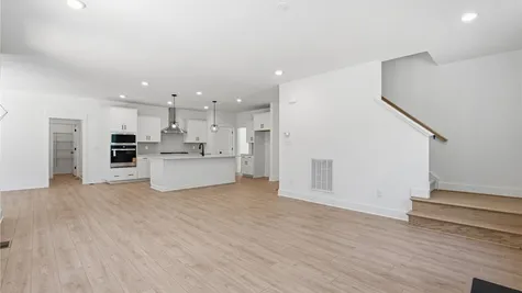 Great room to kitchen- Photo represents the actual home