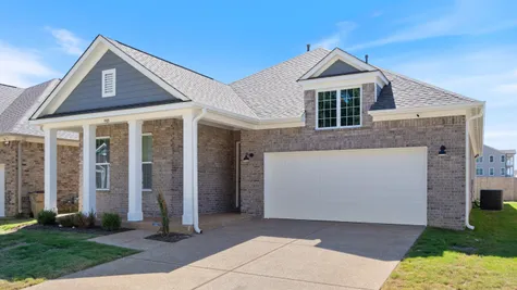 Brick exterior with a gabled roof and a two-car garage