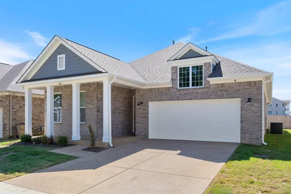 Brick exterior with a gabled roof and a two-car garage