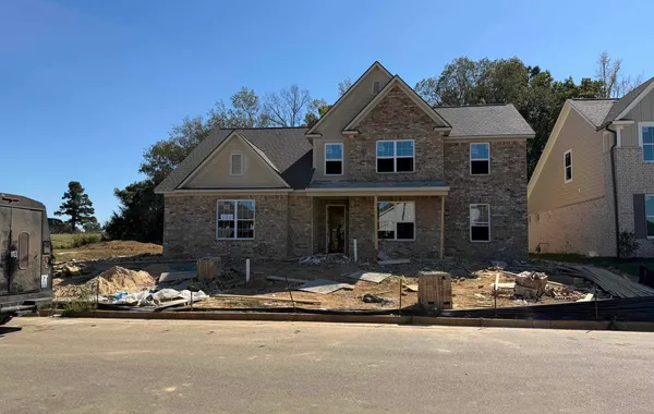 Two-story residence featuring a brick and siding exterior with a covered front entrance
