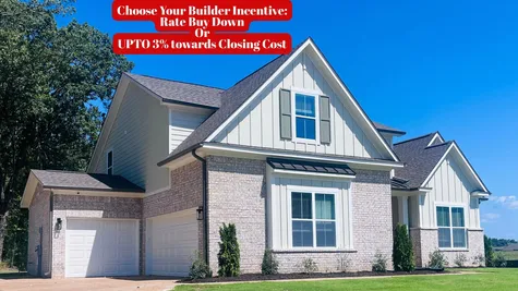 Two-story exterior featuring a brick and board-and-batten facade, multi-gabled roofline, dual-bay garage, and dark-toned shutter accents