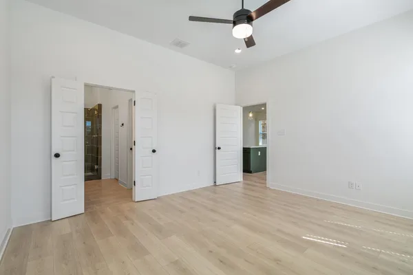 Recessed lighting, wood-finish flooring, ceiling fan with integrated lighting, and panel doors