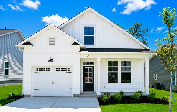 Crisp vertical siding paired with a welcoming cove