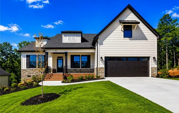 A crisp concrete driveway leads to this modern two