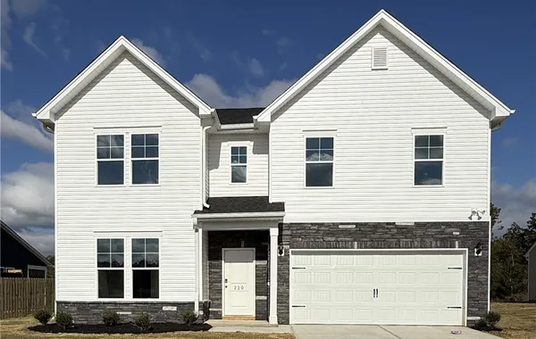 Crisp white siding pairs elegantly with stone acce