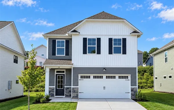 Vinyl siding meets classic stone accents on this m