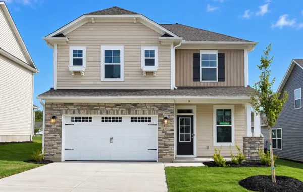 Charming stone accents and vertical siding create