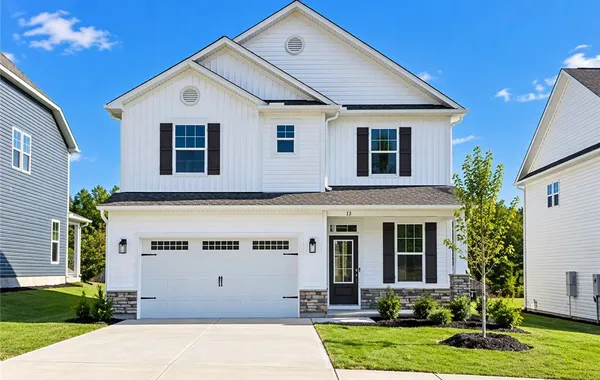 Crisp vertical siding paired with stone accents de