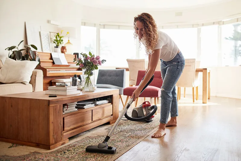 Woman Vacuuming the Living room rug