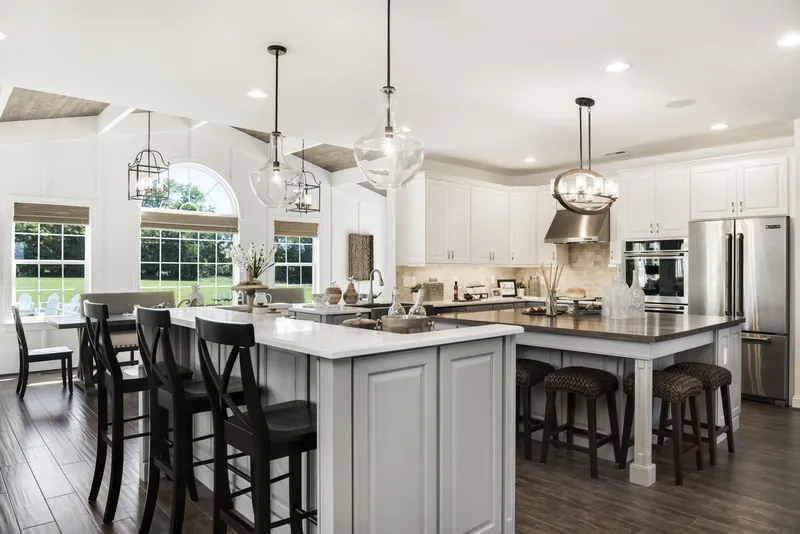 Kitchen with white cabinets and a center island in a Hallmark home