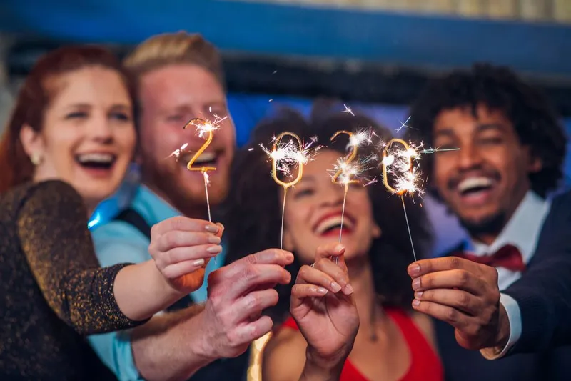 People Celebrating New Years 2020 With Sparklers