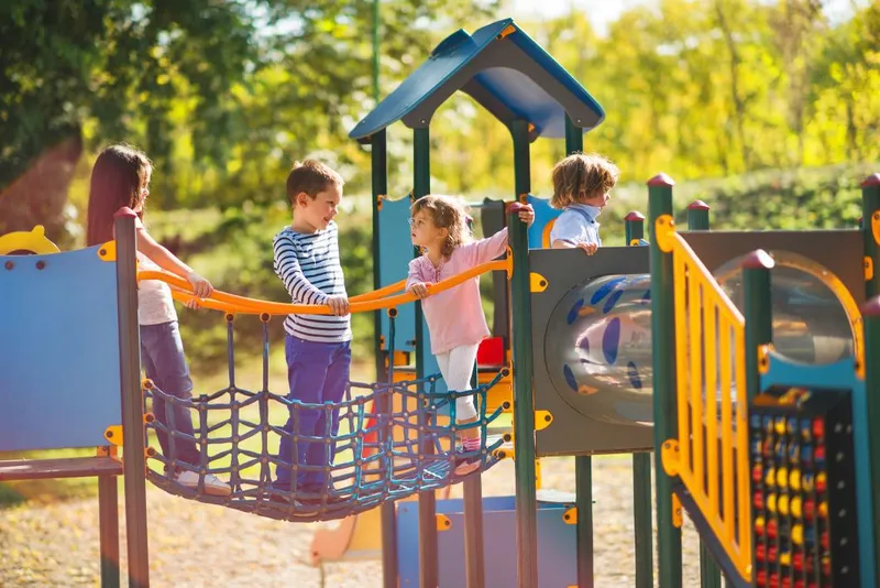 Four Children Playing Together on the Playground