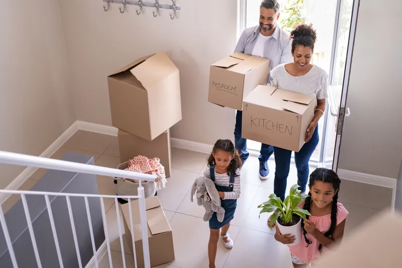 Family Carrying Boxes into their new Hallmark Home