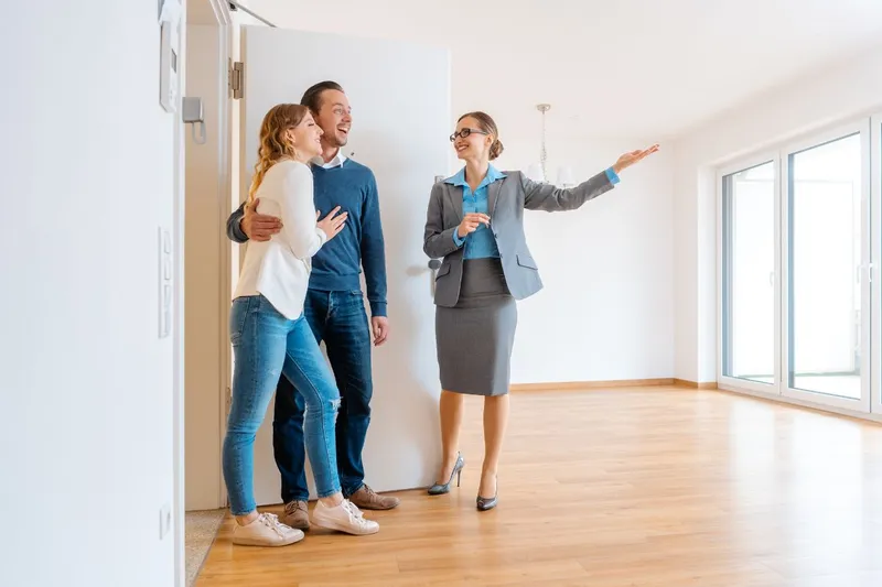 Realtor Showing a Happy Couple the Inside of a Home