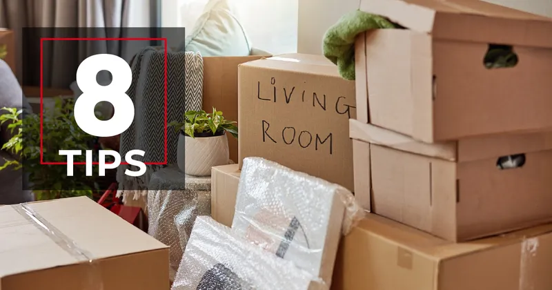 Moving boxes being packed with "8 TIPS" in the Homes by Taber design in the top left corner.