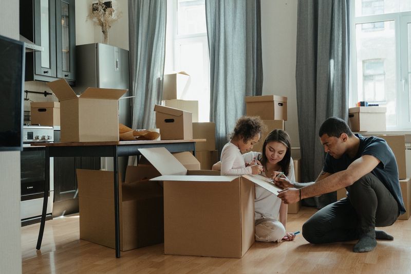 Family Packing Up Boxes for Moving Out of State