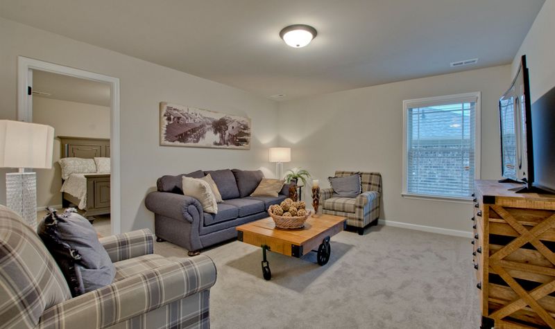 Grey Couches in a Living Area With TV Mounted on the Wall
