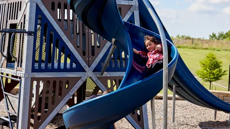  Girl sliding on playground in Native Plains - new homes in Moore, OK
