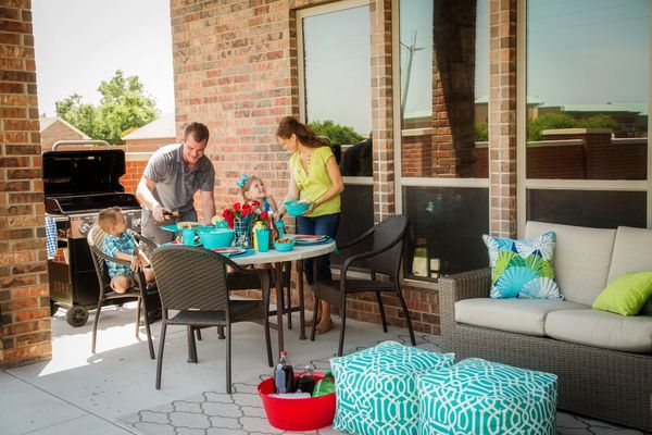  Family cooking out on the back patio of a home in Choctaw, OK
