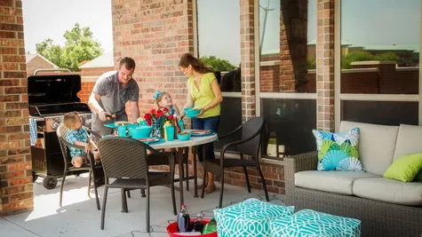  Family cooking out on the back patio of a home in Choctaw, OK