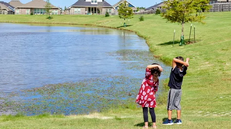  Kids throwing rocks in pond in Native Plains - new homes in Moore, OK
