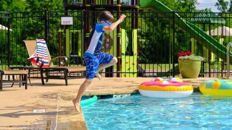 Abernathy. Child jumping in the community pool