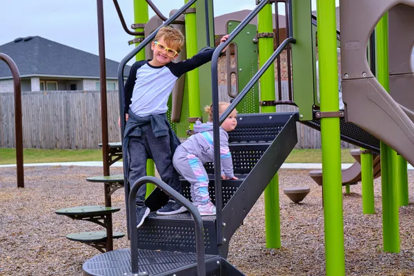 2 children playing on playground in Blanchard, OK