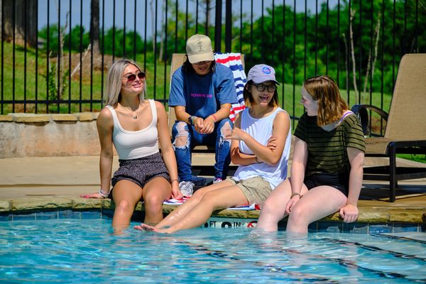  Teenagers hanging out at the pool in Little River Trails - new homes in Norman, OK