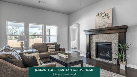 Jordan. living room with fireplace in new home