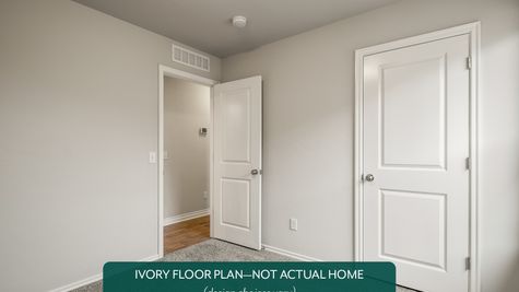 Ivory. Example photo of secondary bedroom in new home in Norman, OK