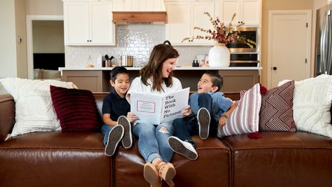  Family reading book in living room
