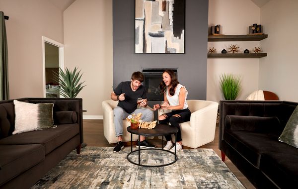 Man and woman playing jenga in the living room of a new home in Choctaw, OK