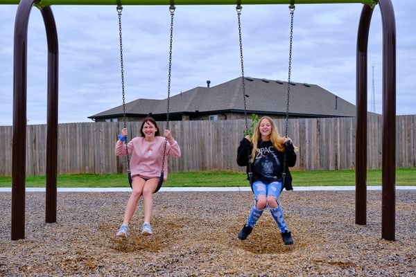  2 teenage girls on swings in Blanchard, OK