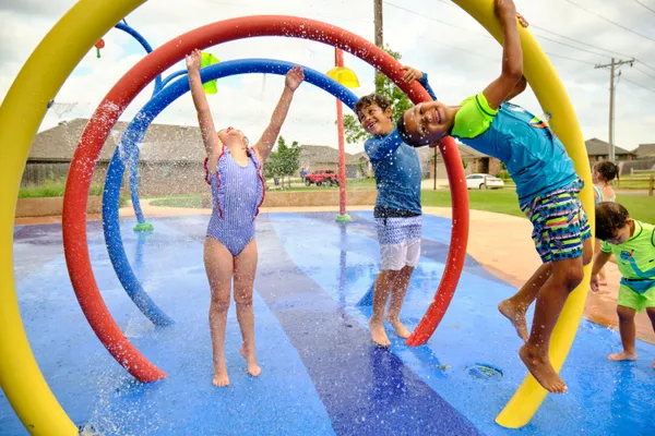  Children at a splashpad in Trail Woods - new homes in Norman