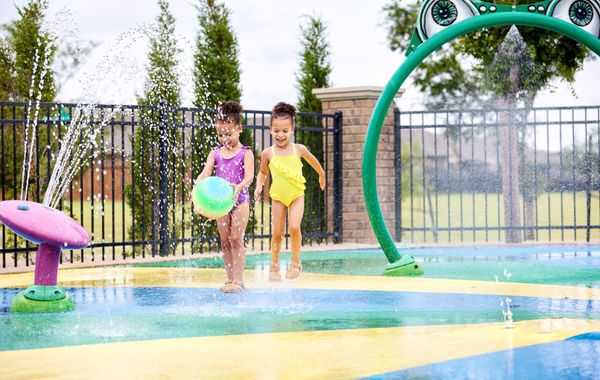 Girls playing at splash pad in Valencia - new homes in Edmond, OK