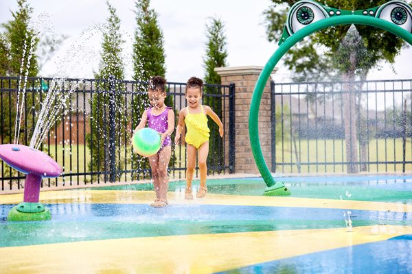  Girls playing at splash pad in Valencia - new homes in Edmond, OK