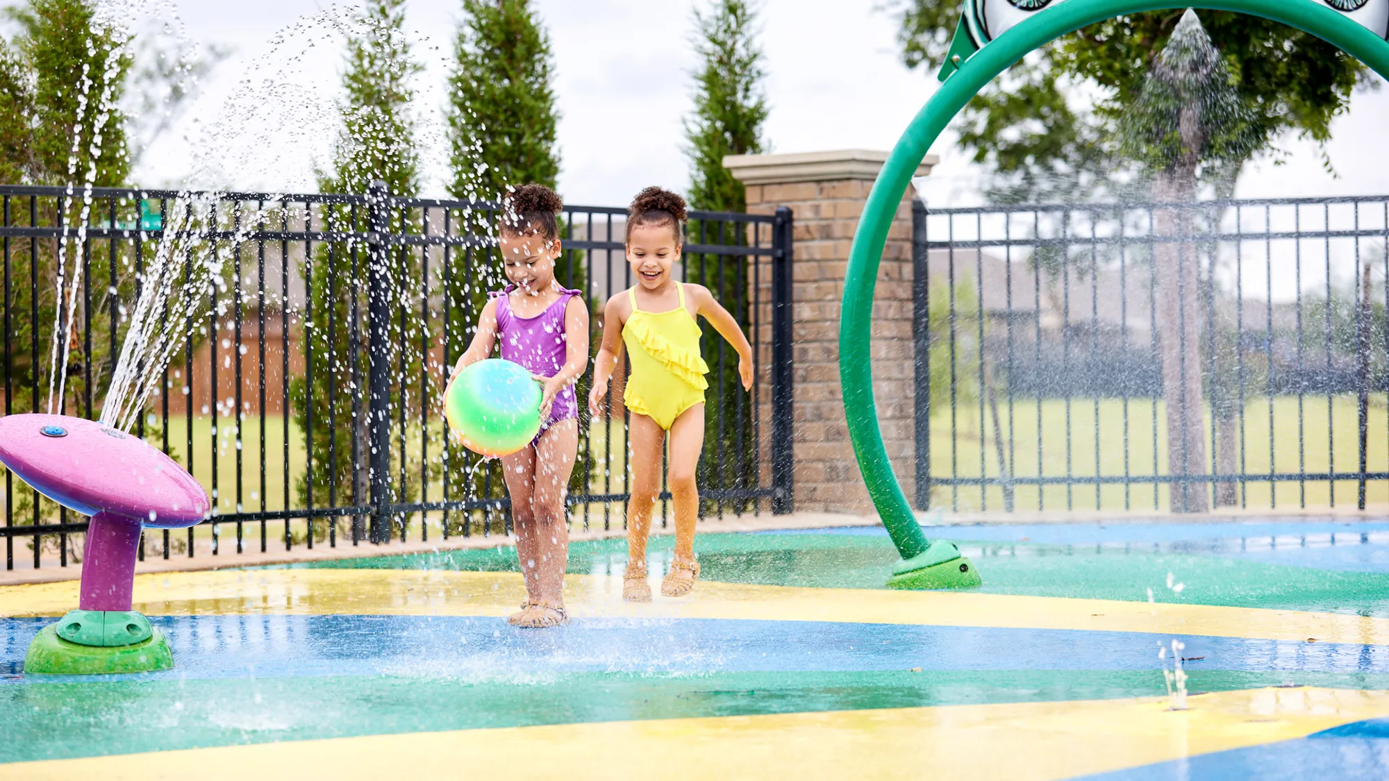  Girls playing at splash pad in Valencia - new homes in Edmond, OK