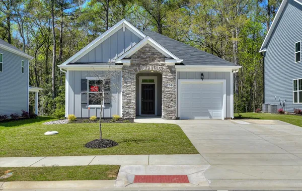A brand new Ivey Homes ranch plan single-family house with an elegant stone arch entryway, nestled in the serene woodlands of North Augusta, SC 29841.