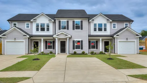 Front view of a brand-new Athens plan 2-bedroom townhome with garage and covered patio located at 627 Hampton Drive in Windsor, North Augusta, SC.
