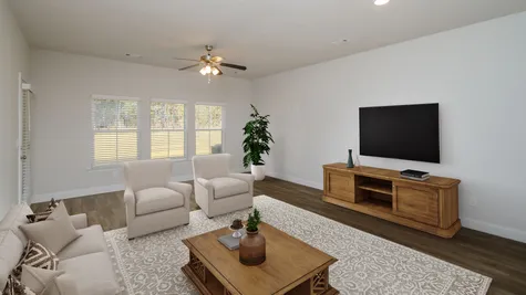 A bright and airy living room with ample space, featuring contemporary design in the new townhomes at 1012 Candleberry Drive, Grovetown, GA by Ivey Homes.
