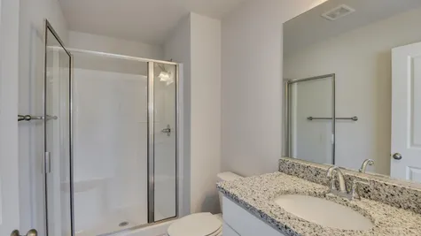 A sleek and stylish bathroom within the newly constructed townhome for sale at 878 Rachel Branch Forrest Bluff by Ivey Homes, featuring contemporary fixtures and finishes, ready for immediate move-in.