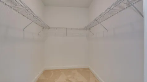 Interior view of the large walk-in closet in the primary bedroom of the new construction home by Ivey Homes located at 854 Rachel Branch Forrest Bluff, North Augusta, SC 29841.