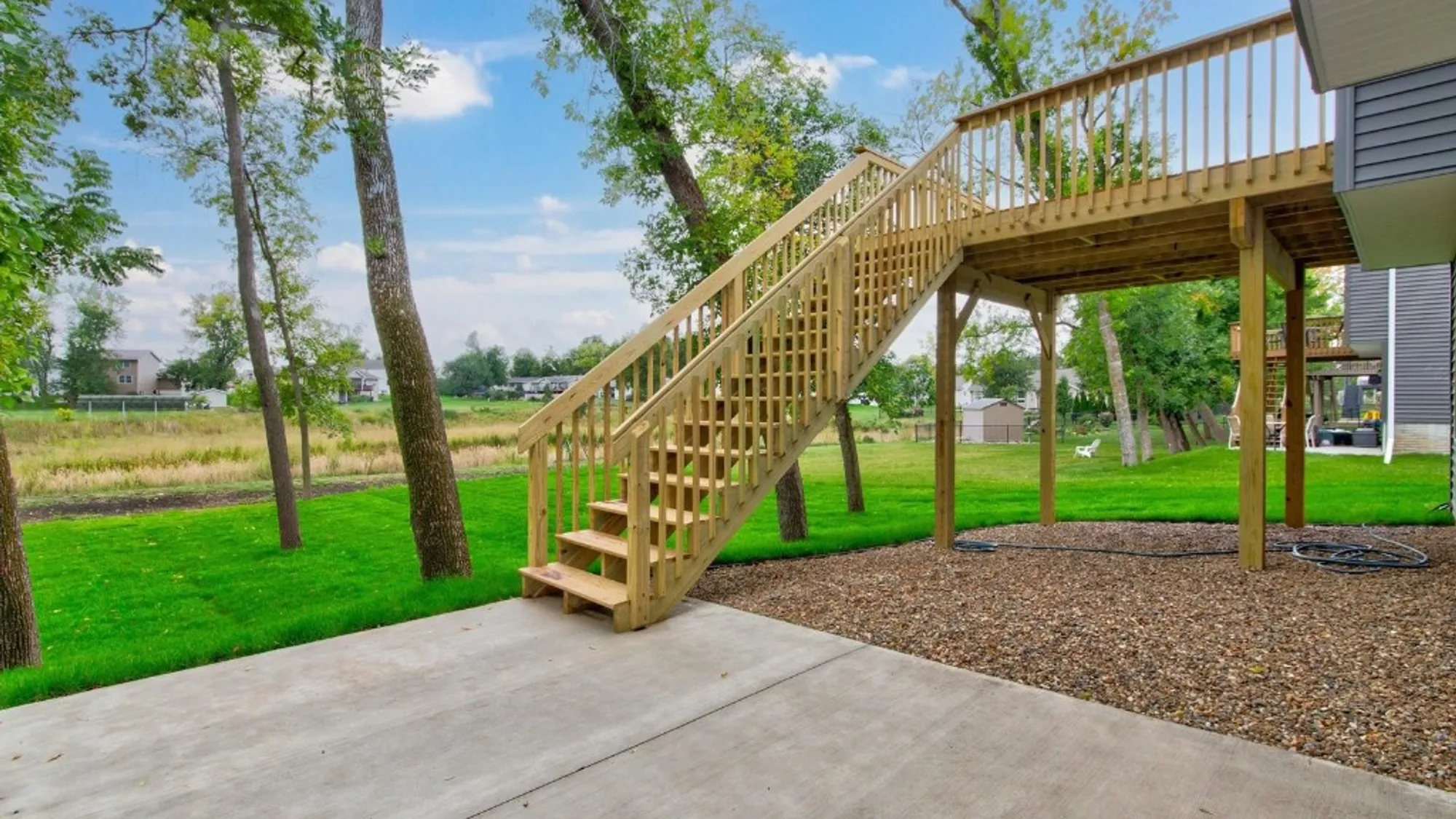 Enjoy nature from the deck or patio lot backs up to green space